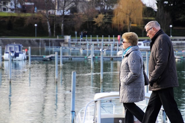 senior couple strolling at marina