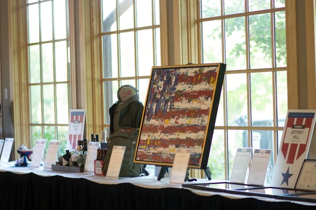 Silent auction of a fundraising gala set against the backdrop of  the golf course at Hazeltine National Golf Club
