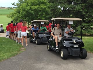 Players head out to the shotgun start of a private golf tournament at Hazeltine National Golf Club
