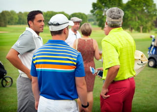 Golfers chatting after finishing play in a private golf tournament at Hazeltine National Golf Club