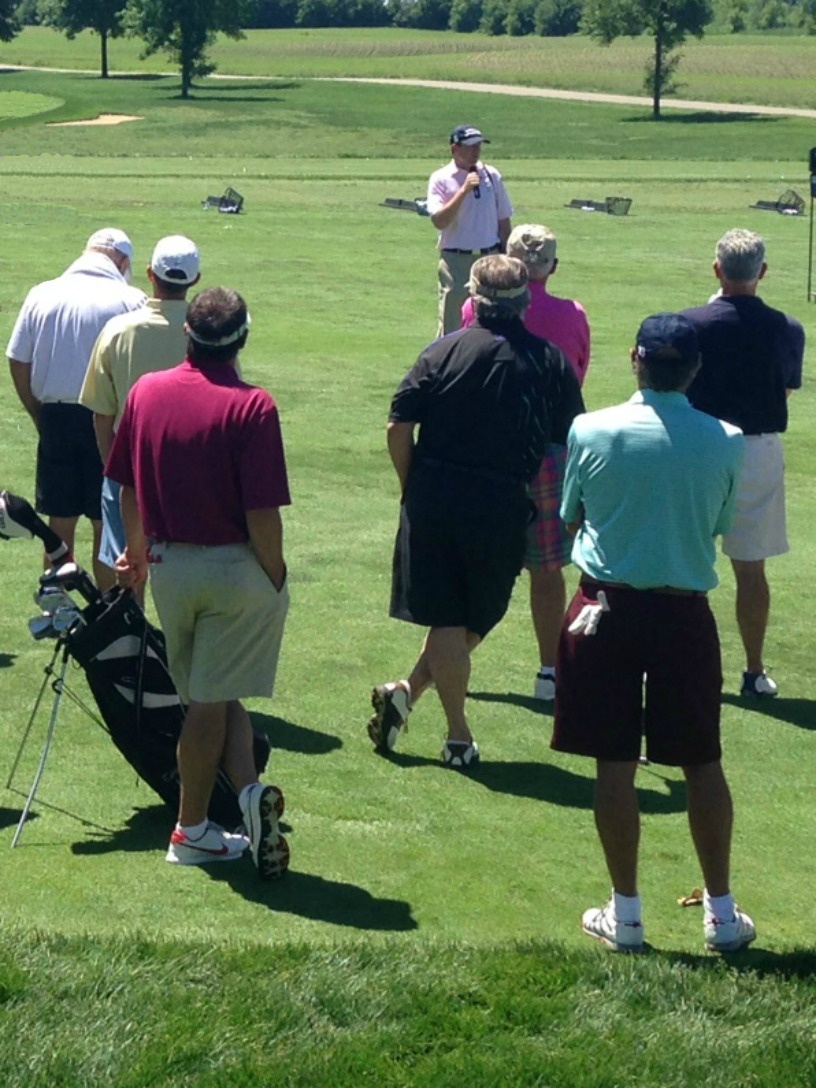 Golfers listen to instruction during a business networking event at Hazeltine National Golf Club