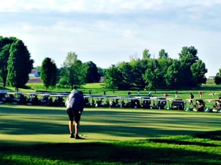 Golfer practices putting before a private golf tournament at Hazeltine National Golf Club