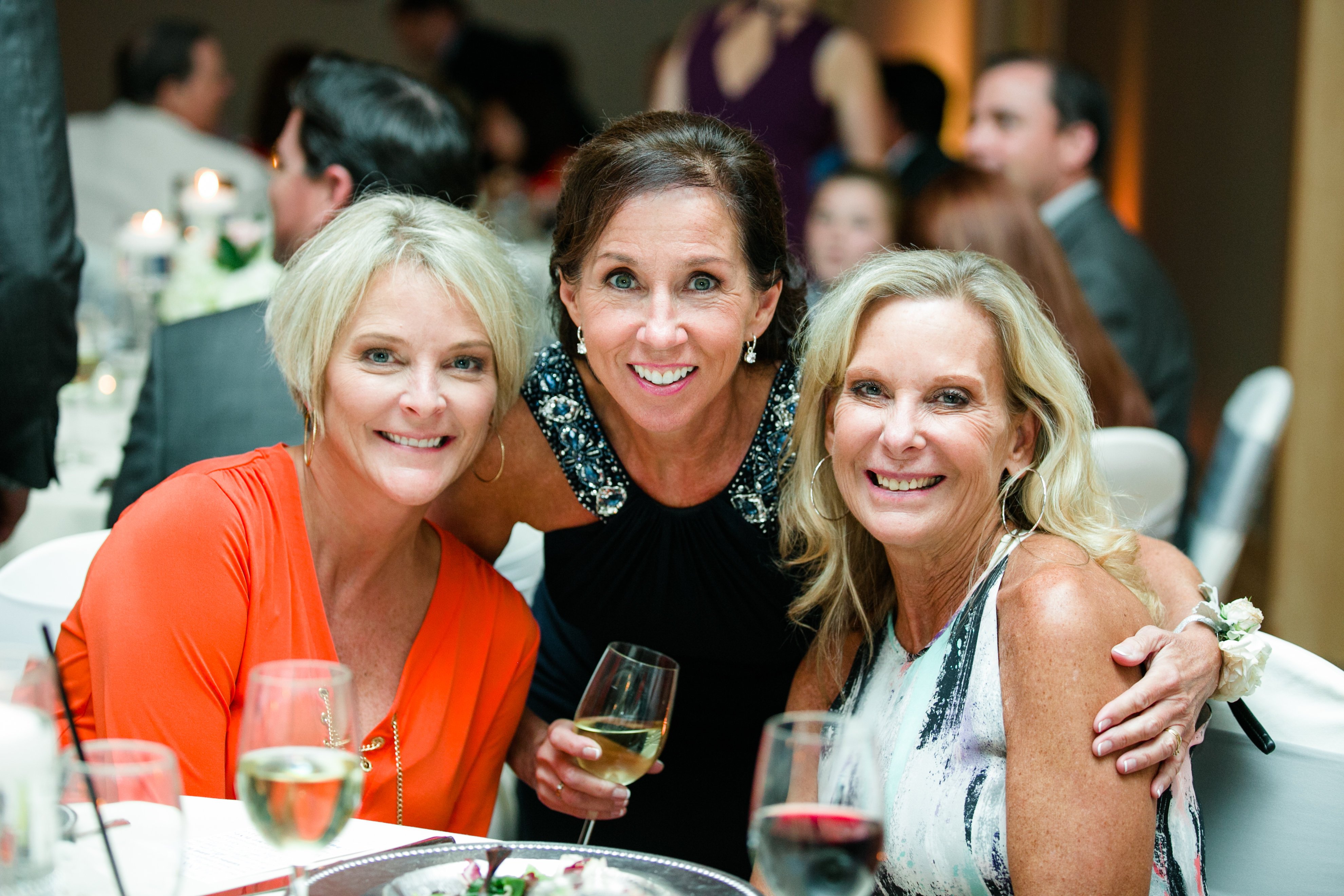 Women enjoying dinner at a fundraising gala at Hazeltine National Golf Club