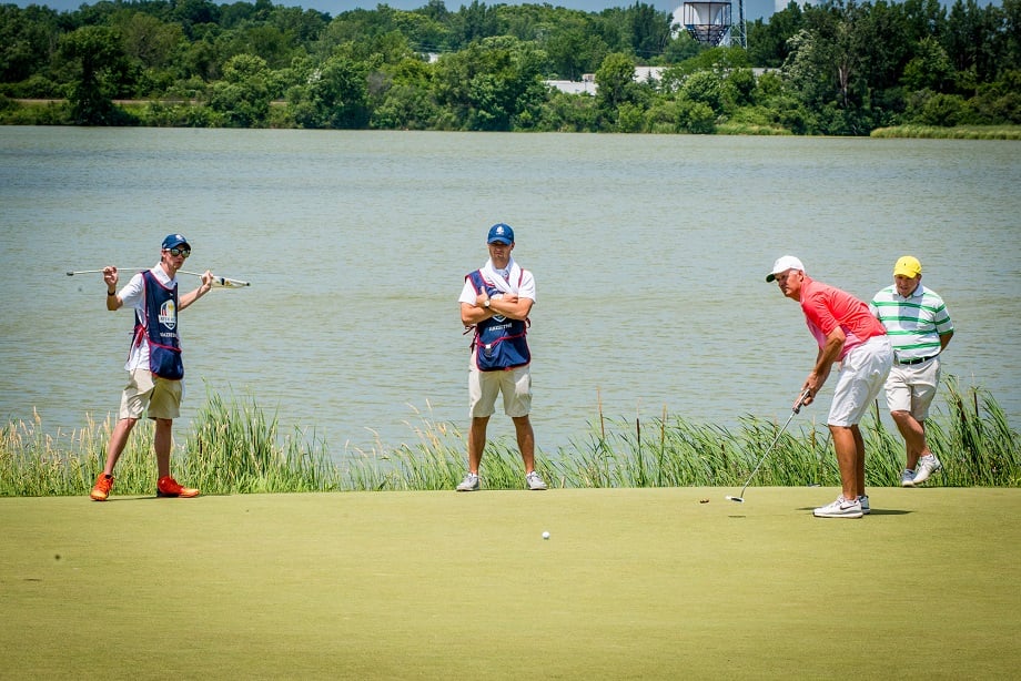 four individuals golfing at hazeltine